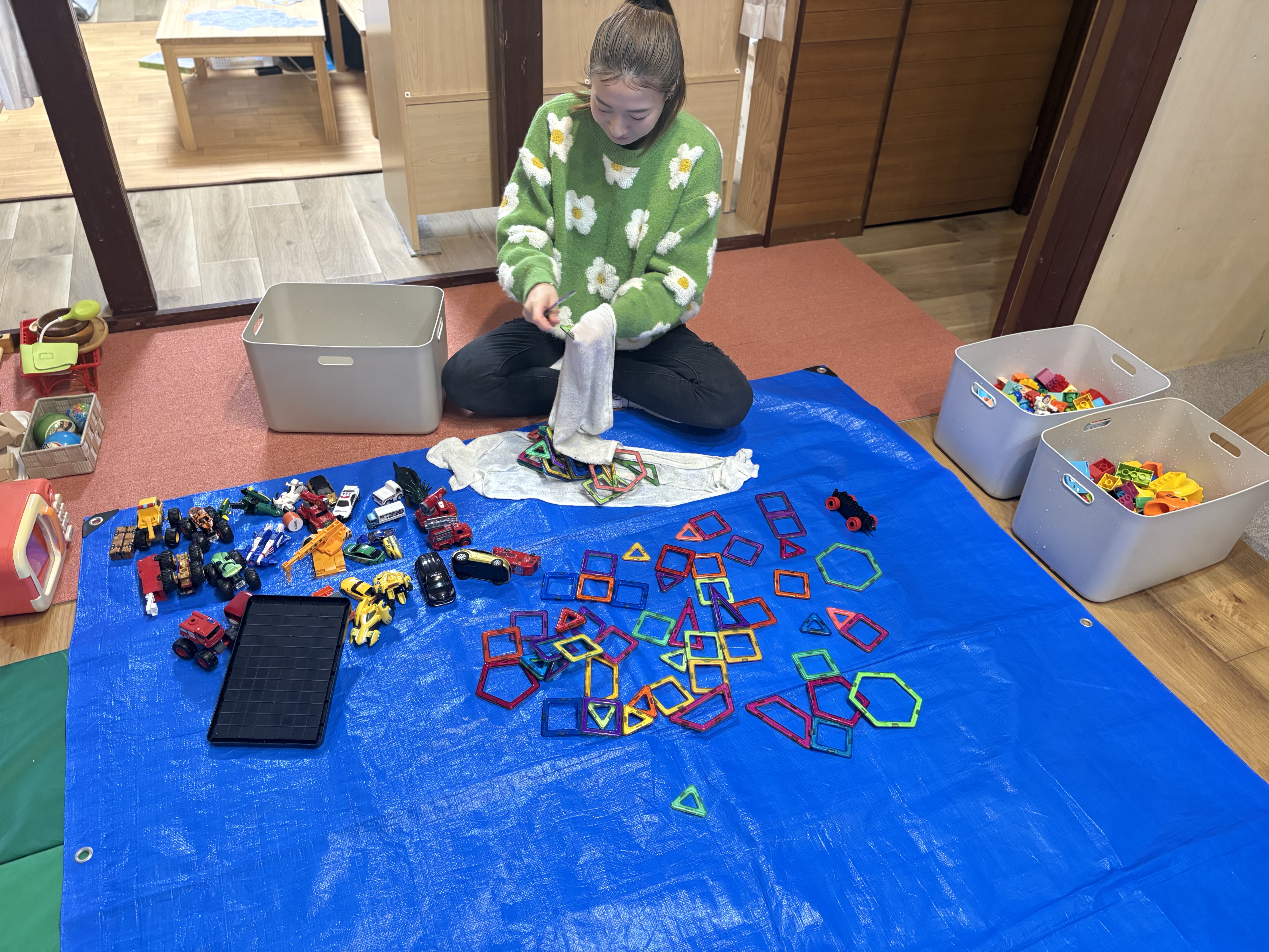 スタッフのリズちゃんは、触読した玩具を一個ずつ拭く作業を担当する。