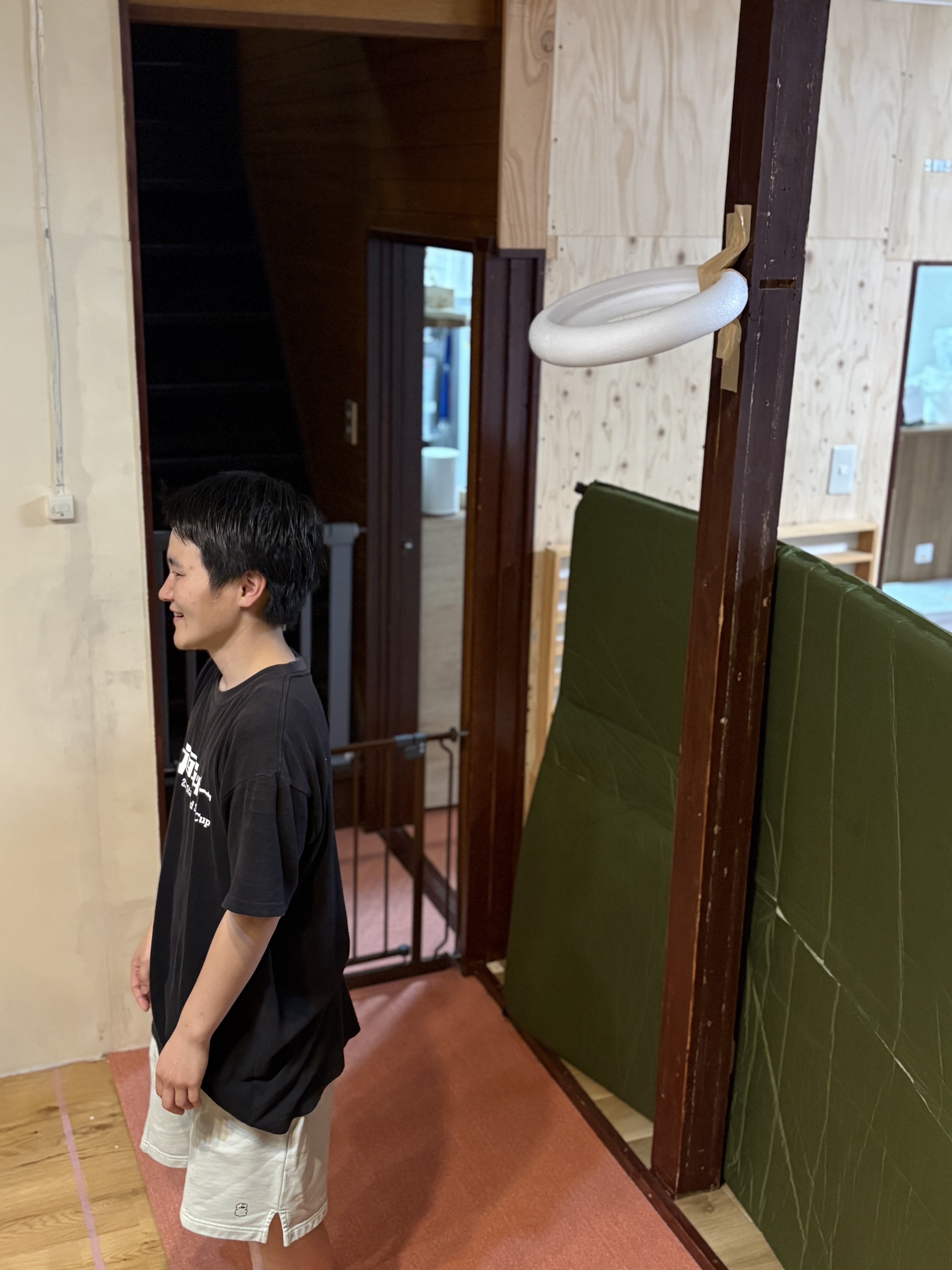 「『これならボールが当たっても安全だね！』みんなで工夫した特製ゴール」
大型木工遊具の柱や梁にしっかり固定され、お部屋にバシッと出現した手作りの特製バスケットゴールのクローズアップ。