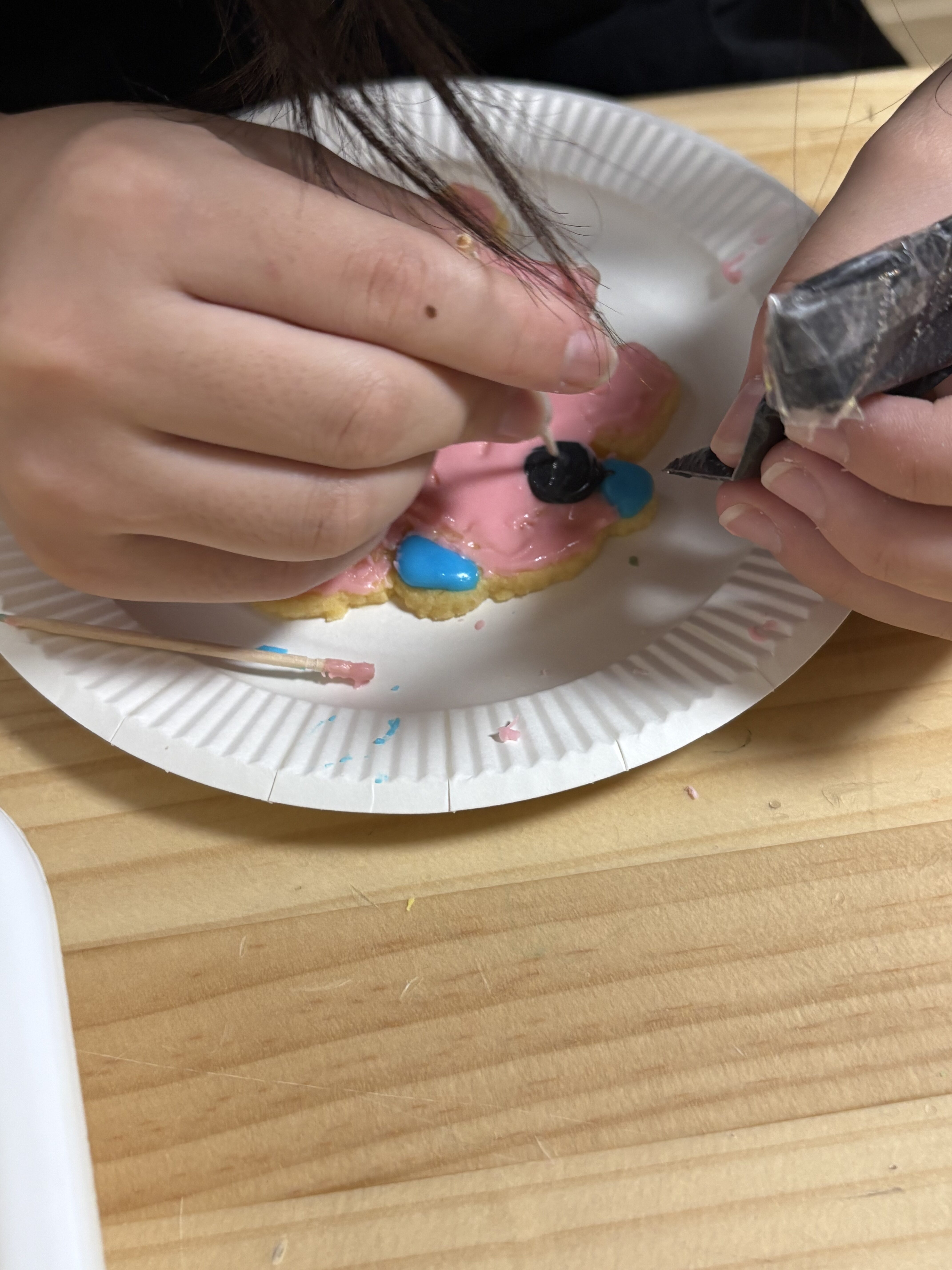 「爪楊枝の技!細かいディテールまでこだわっておめめを描く表情」
爪楊枝の先を使って、キャラクターの可愛いおめめやお口を少しずつ慎重に描き込んでいる、職人のような子どもたちの真剣な目元。