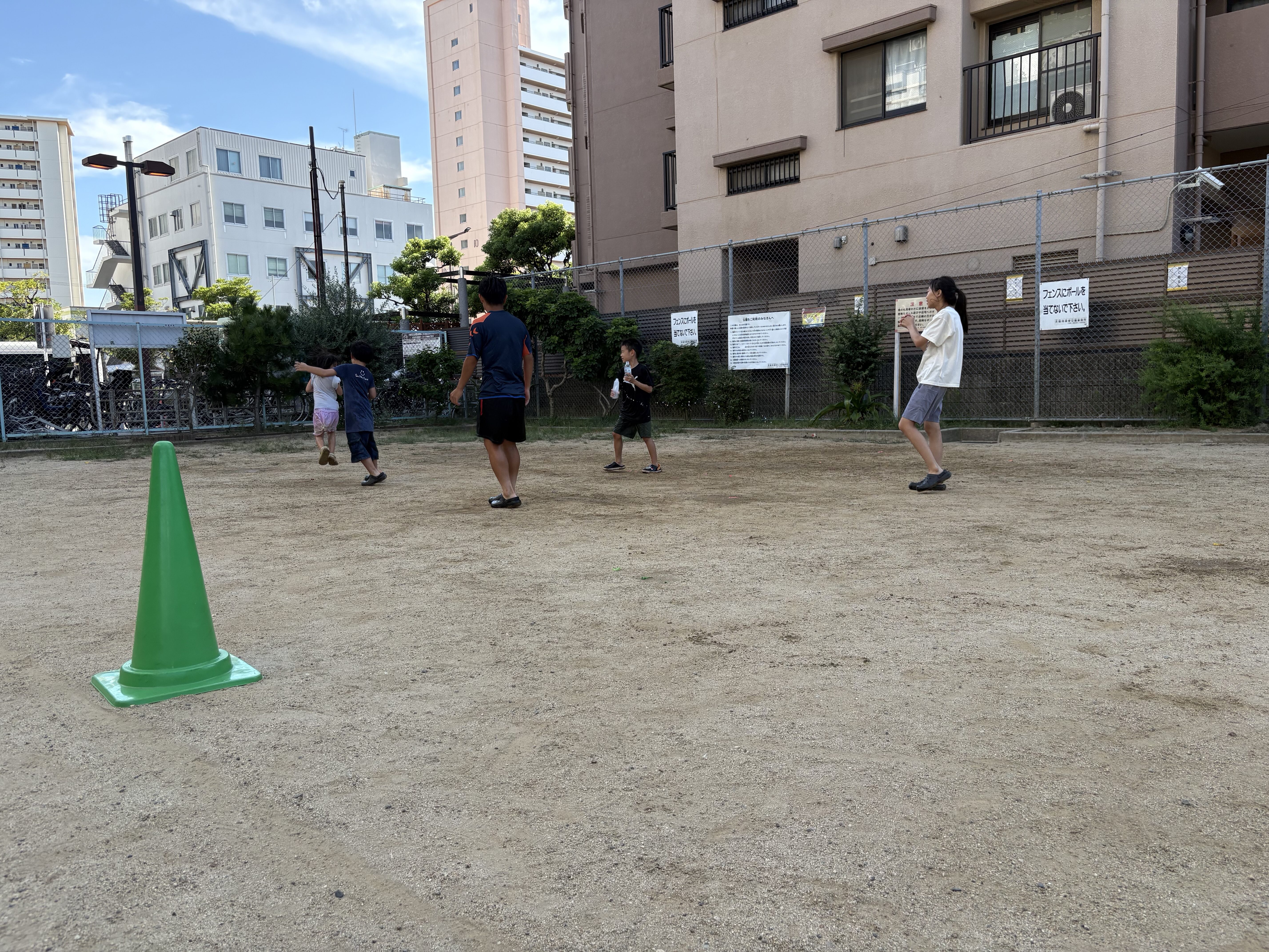 「『着替えもタオルも準備完了!』いざ目の前の公園へ出発!」
水風船やペットボトルを大切そうに手にして、ワクワクした表情で公園へ向かう子どもたちの後ろ姿&笑顔カット。